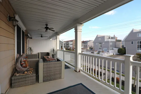 a view of a balcony with couches and wooden floor