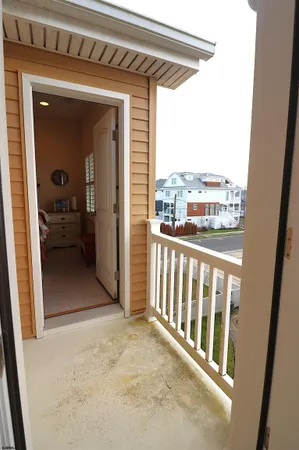 a bedroom with a bed and dresser with window