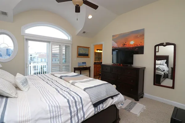 a bathroom with a granite countertop sink toilet a large mirror and shower