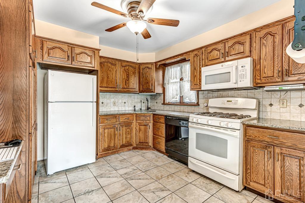 20 Codington Place Somerville, NJ 08876 - Photo 11 of 36 a kitchen with stainless steel appliances granite countertop a refrigerator sink and stove