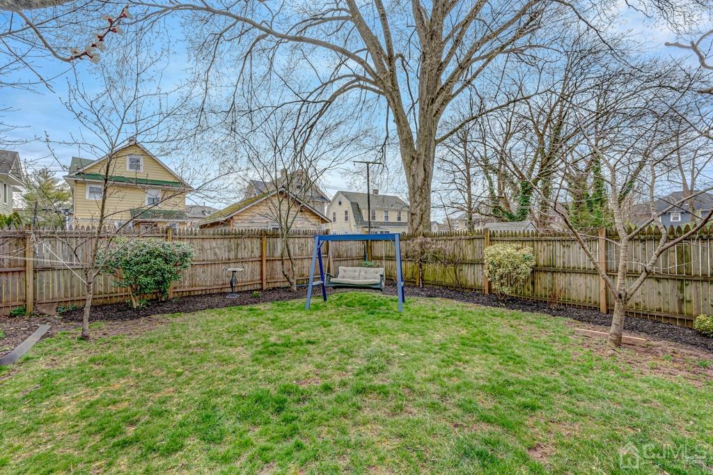 20 Codington Place Somerville, NJ 08876 - Photo 17 of 36 a view of a backyard with a garden and swing