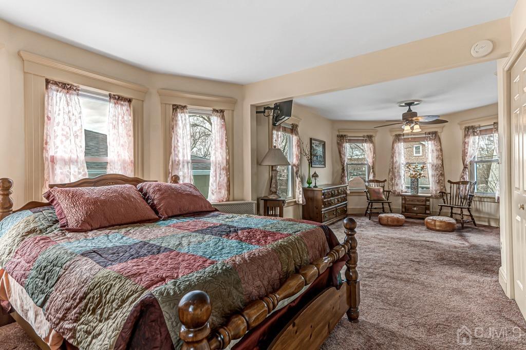 20 Codington Place Somerville, NJ 08876 - Photo 18 of 36 a bedroom with a bed a couch and large windows