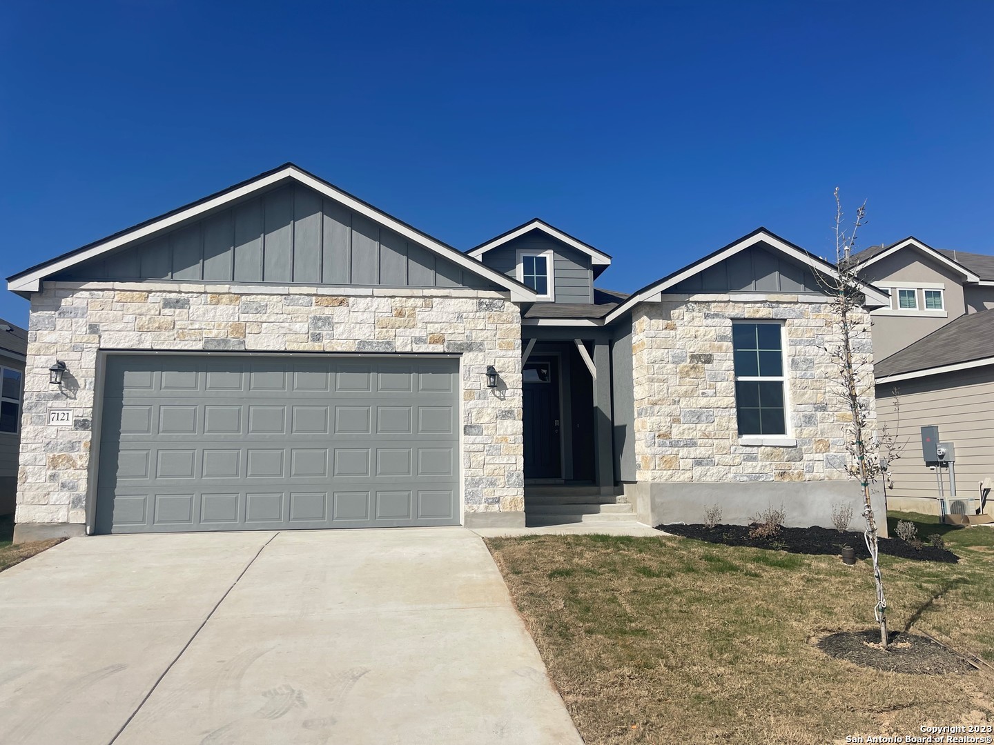 a front view of a house with garage
