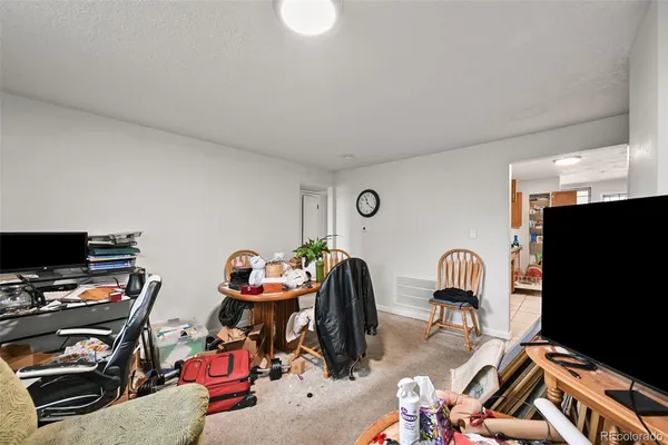a bedroom with furniture and a flat screen tv