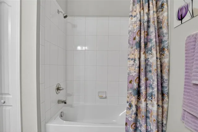 a view of a hallway with furniture and wooden floor