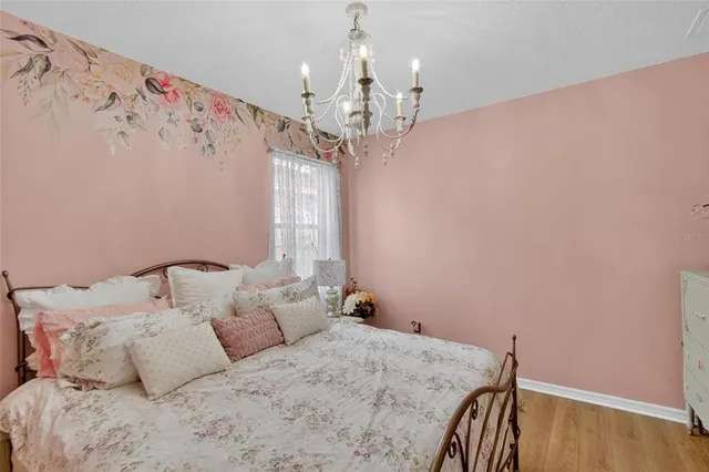 a bedroom with a bed and flat screen tv