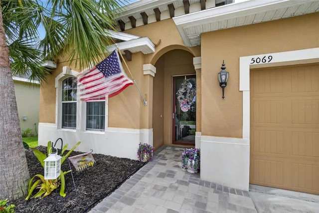 a view of a hallway with wooden floor and a living room