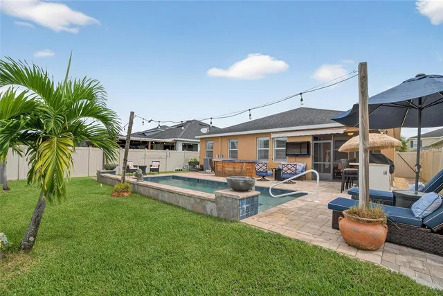 a view of a house with a yard balcony and a patio