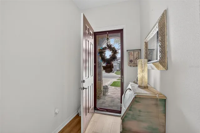 a view of a dining room and livingroom with furniture wooden floor a chandelier