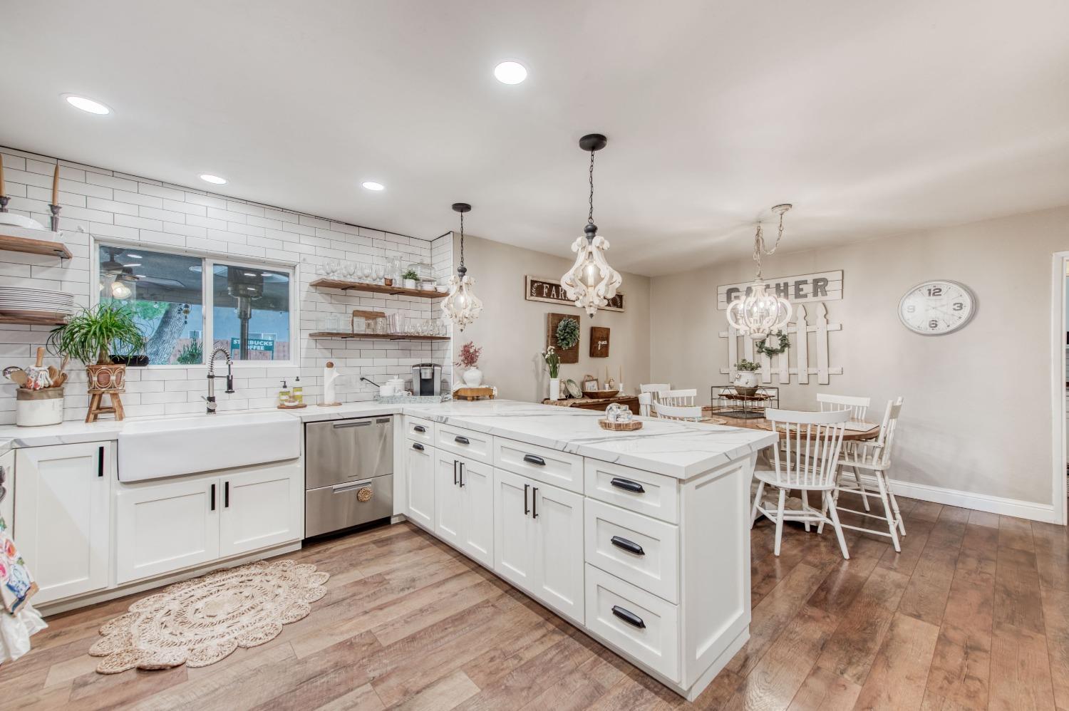 1880 East Cardella Street Firebaugh, CA 93622 - Photo 11 of 42 a kitchen with stainless steel appliances kitchen island granite countertop a sink and cabinets