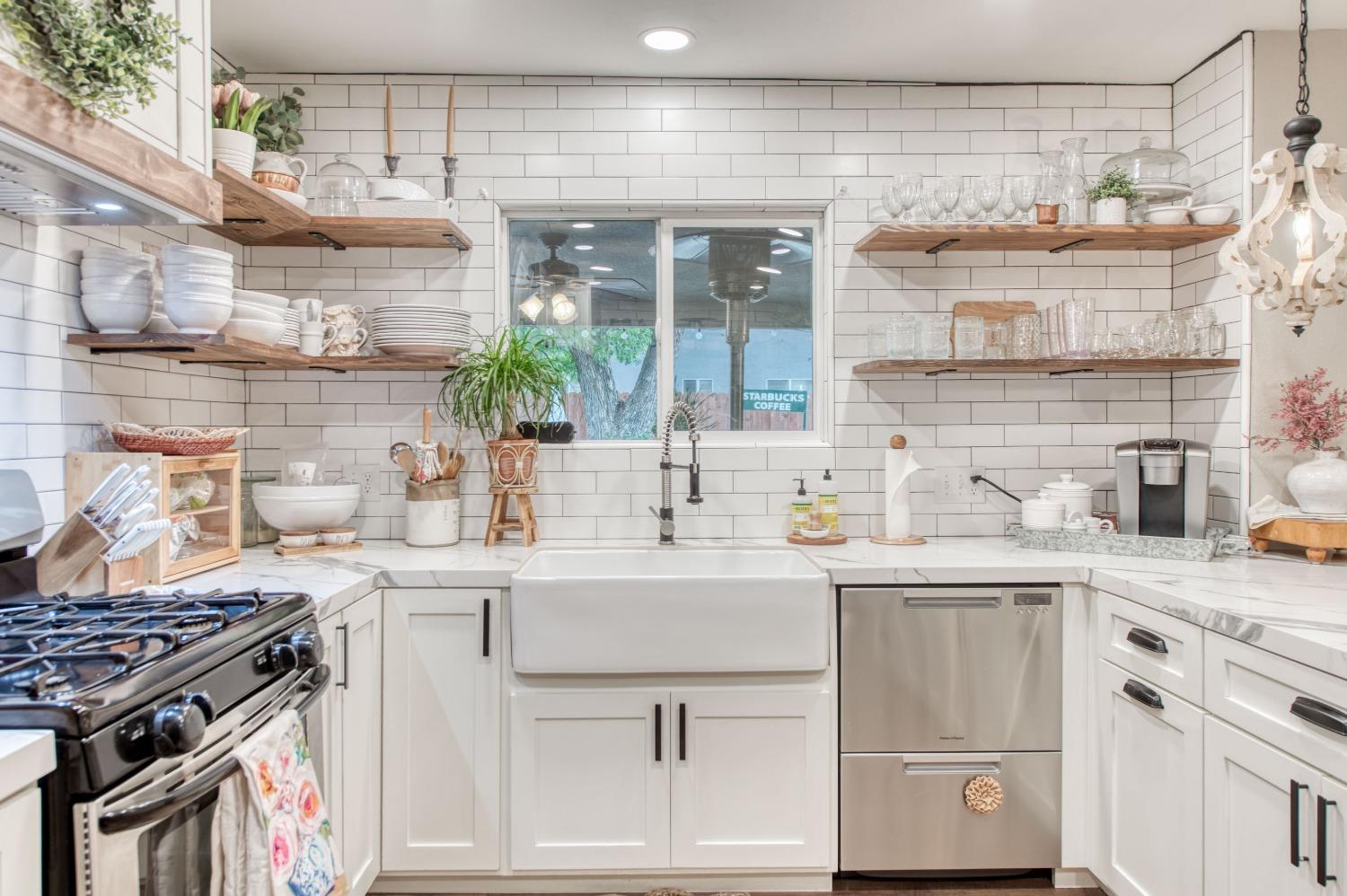 1880 East Cardella Street Firebaugh, CA 93622 - Photo 14 of 42 a kitchen with a sink stove and cabinets