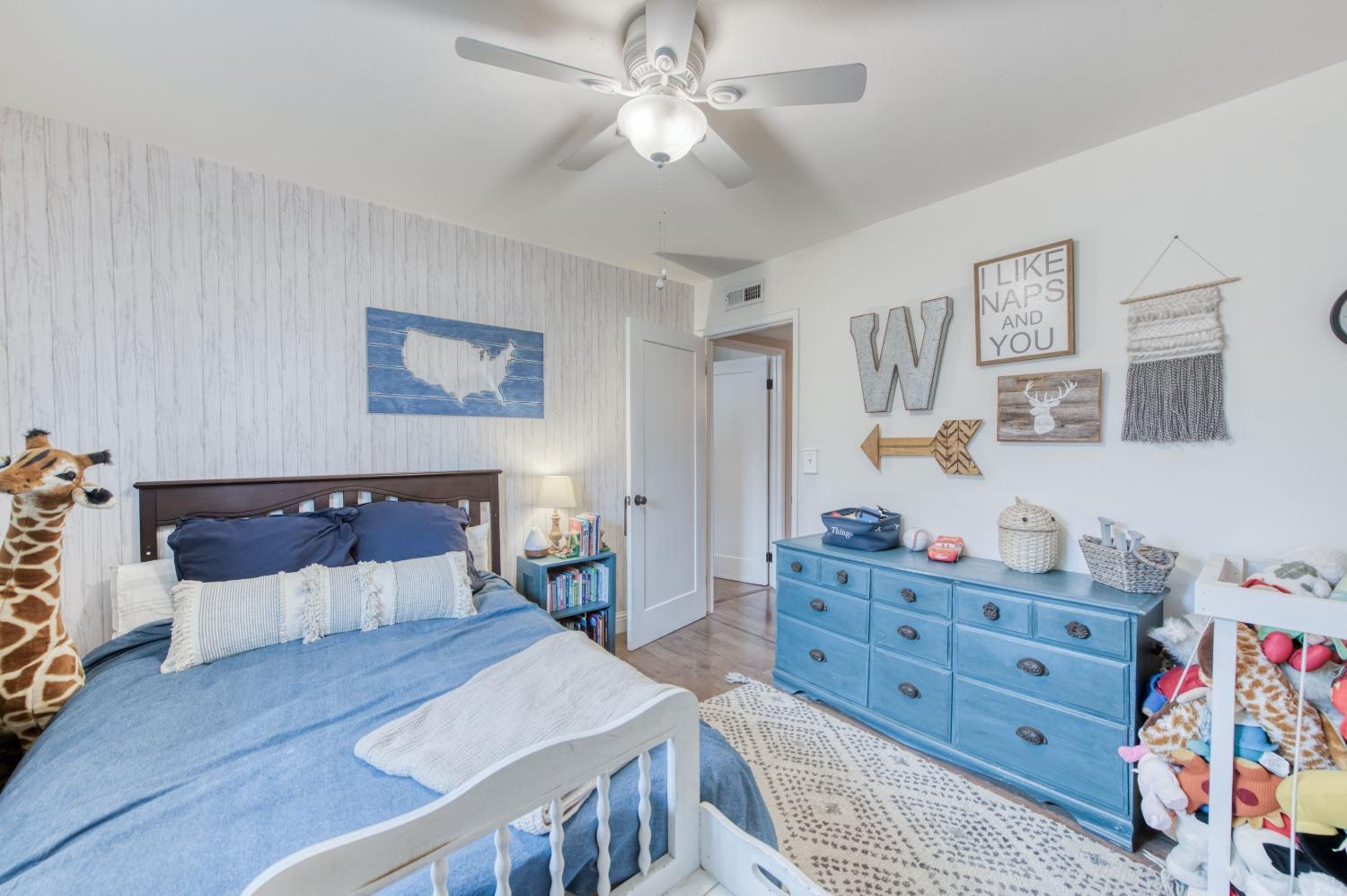 1880 East Cardella Street Firebaugh, CA 93622 - Photo 20 of 42 a living room with furniture and paintings on the wall