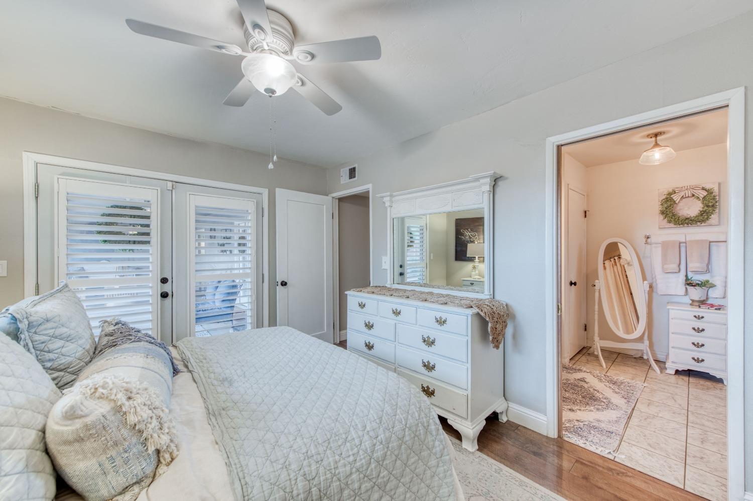 1880 East Cardella Street Firebaugh, CA 93622 - Photo 24 of 42 a bedroom with a bed dresser and wooden floor