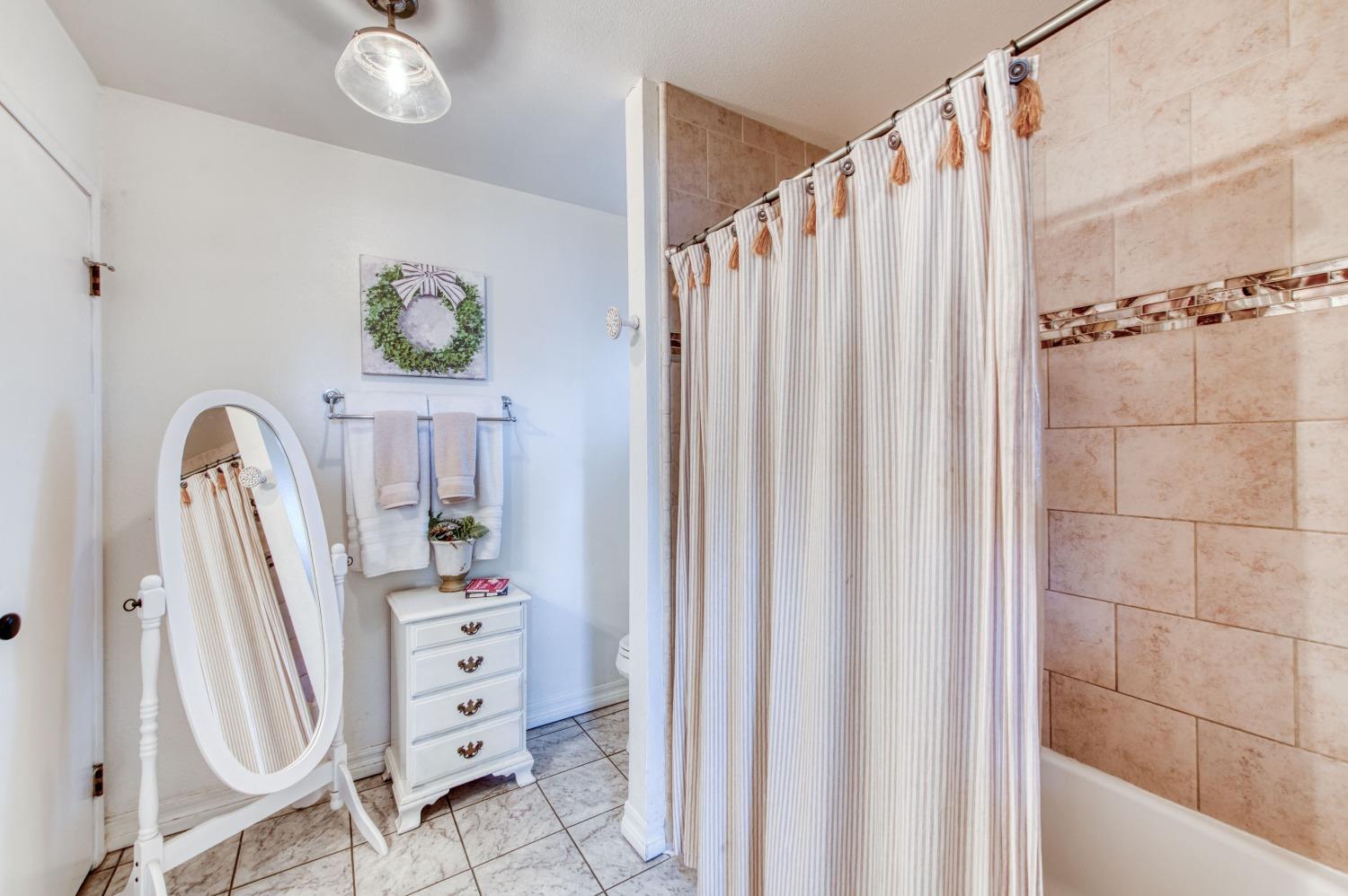 1880 East Cardella Street Firebaugh, CA 93622 - Photo 26 of 42 a view of a bedroom with baby crib and a chandelier