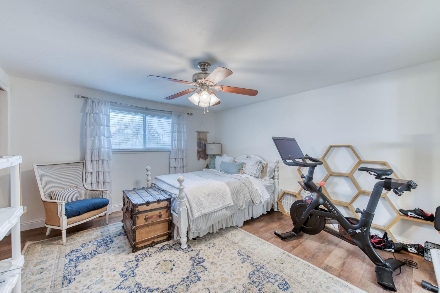 1880 East Cardella Street Firebaugh, CA 93622 - Photo 28 of 42 a bed room with a bed and a chair