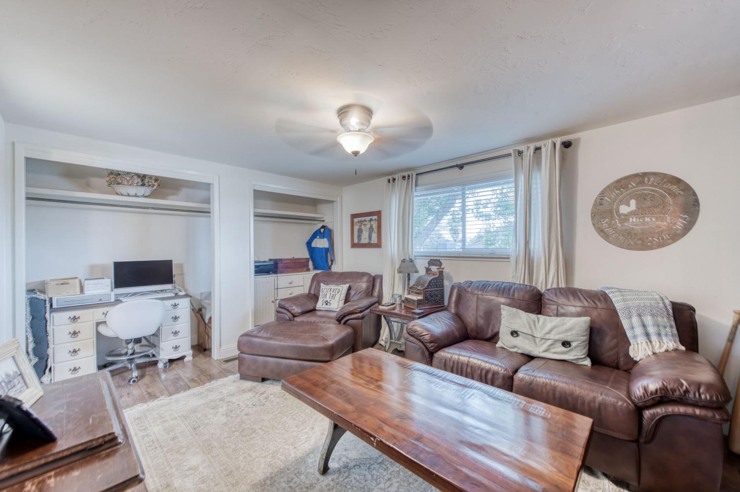 1880 East Cardella Street Firebaugh, CA 93622 - Photo 30 of 42 a living room with furniture a rug and a window