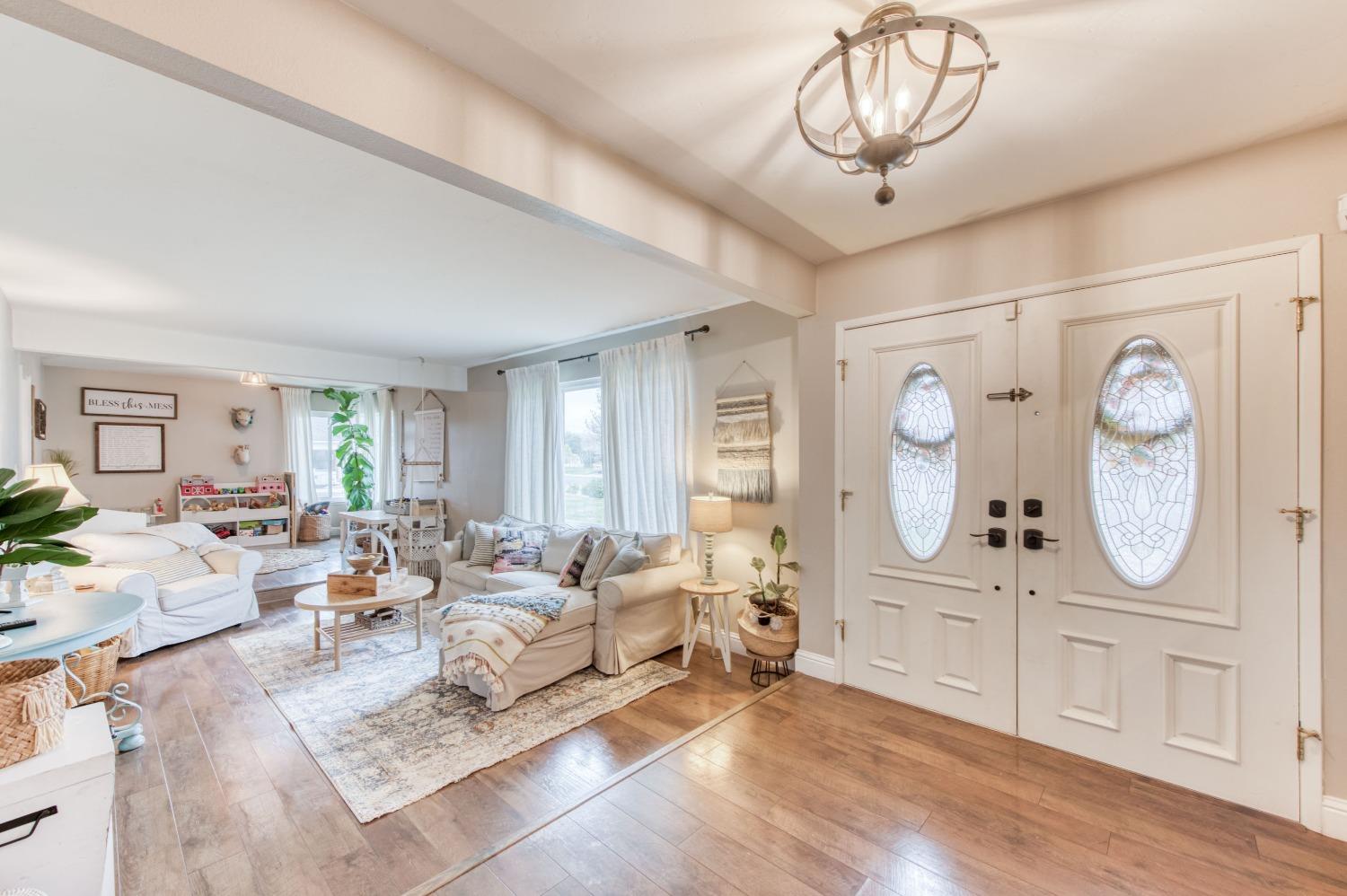 1880 East Cardella Street Firebaugh, CA 93622 - Photo 3 of 42 a living room with furniture a large window and potted plants