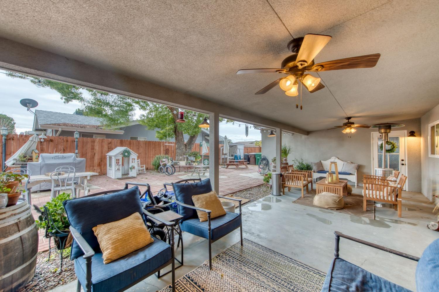 1880 East Cardella Street Firebaugh, CA 93622 - Photo 32 of 42 a living room with furniture fireplace and a large window