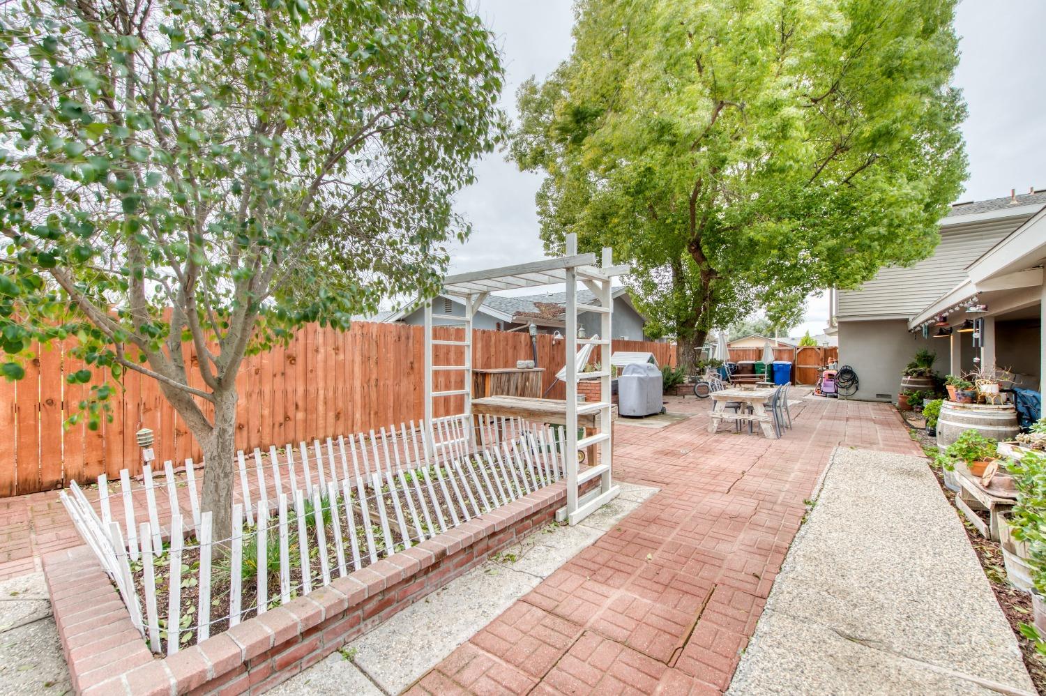 1880 East Cardella Street Firebaugh, CA 93622 - Photo 37 of 42 a view of a dinning table and chairs in patio