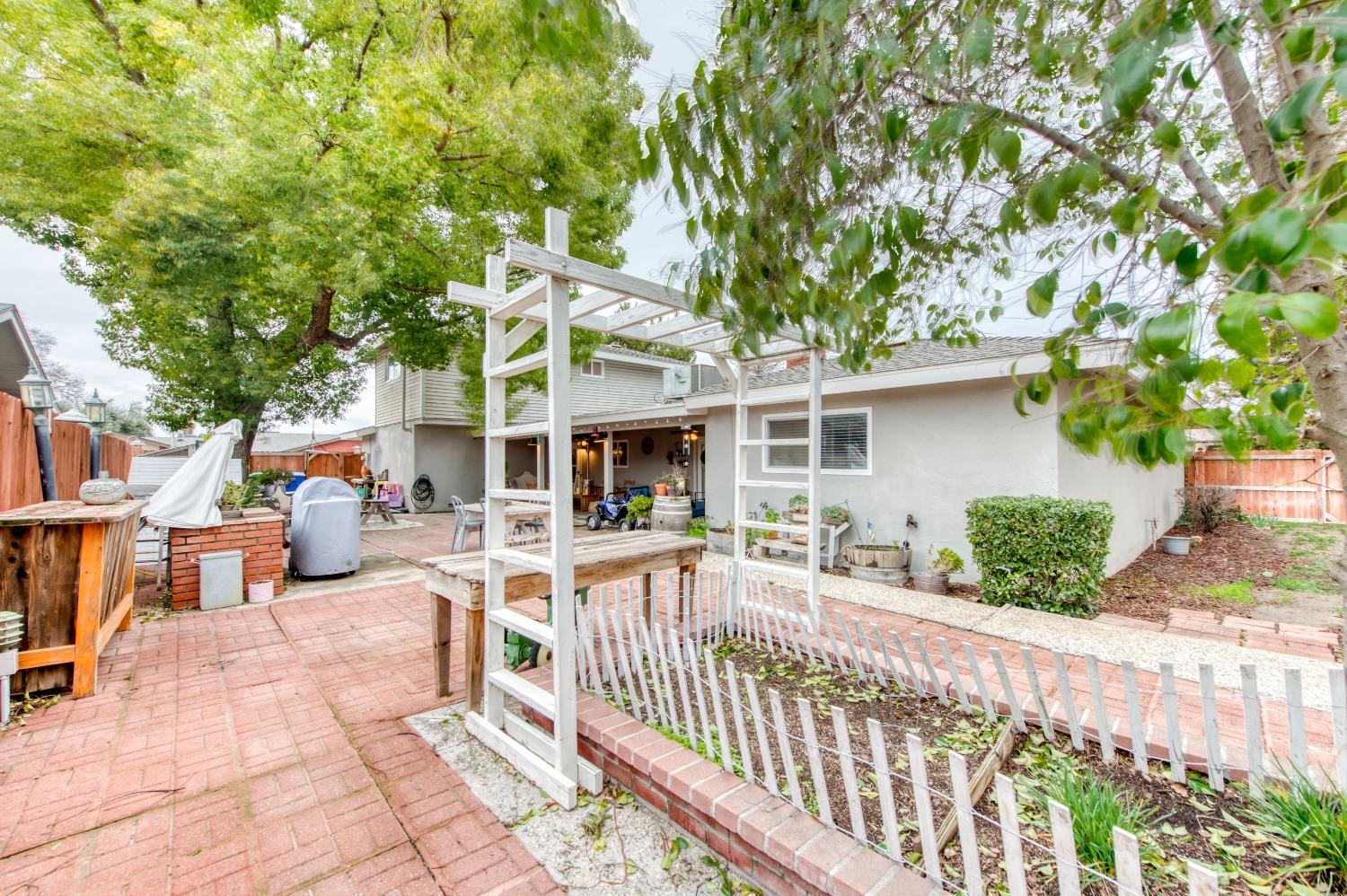 1880 East Cardella Street Firebaugh, CA 93622 - Photo 38 of 42 a view of a patio with couches table and chairs and potted plants