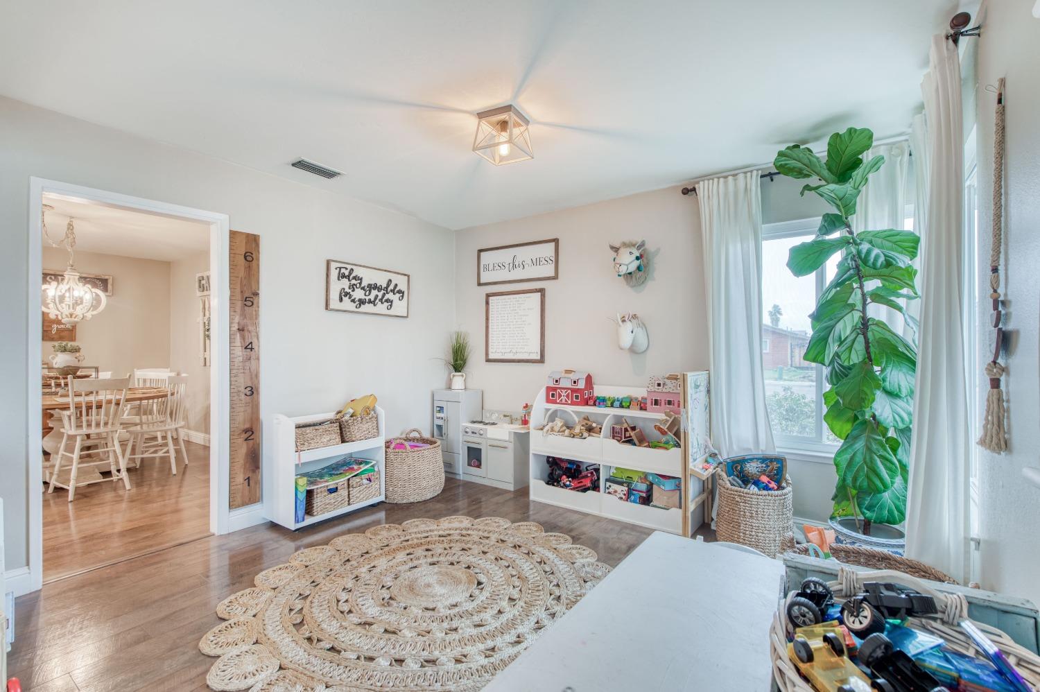 1880 East Cardella Street Firebaugh, CA 93622 - Photo 7 of 42 a living room with furniture and a potted plant