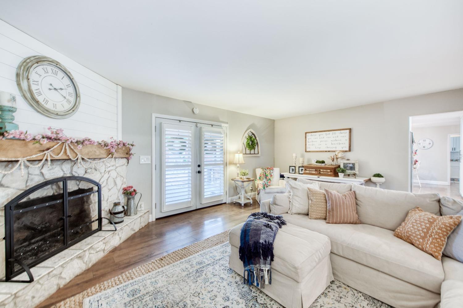 1880 East Cardella Street Firebaugh, CA 93622 - Photo 9 of 42 a living room with furniture a fireplace and a window