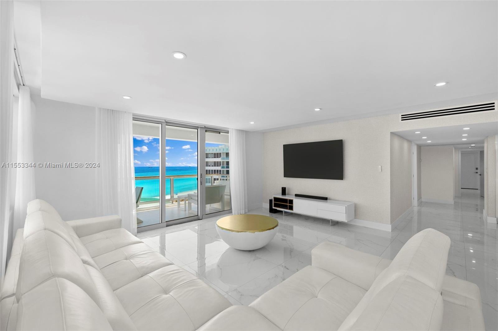 5151 Collins Avenue, Unit 1527 Miami Beach, FL 33140 - Photo 17 of 65 a living room with furniture and a flat screen tv