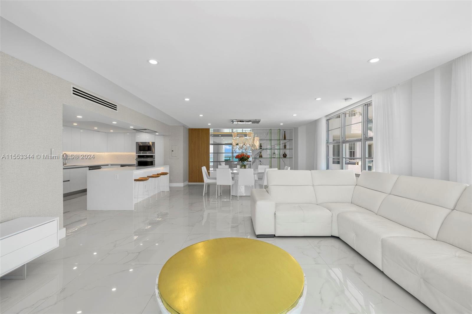 5151 Collins Avenue, Unit 1527 Miami Beach, FL 33140 - Photo 20 of 65 a living room with furniture and a table