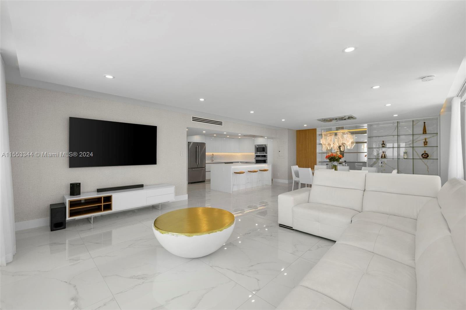 5151 Collins Avenue, Unit 1527 Miami Beach, FL 33140 - Photo 21 of 65 a living room with furniture and a flat screen tv