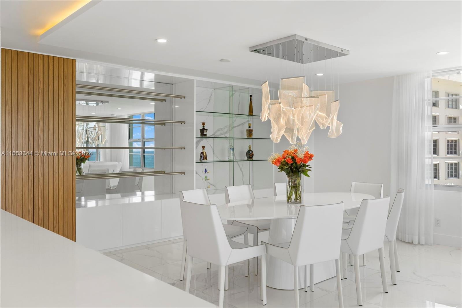 5151 Collins Avenue, Unit 1527 Miami Beach, FL 33140 - Photo 23 of 65 a dining room with furniture and wooden floor