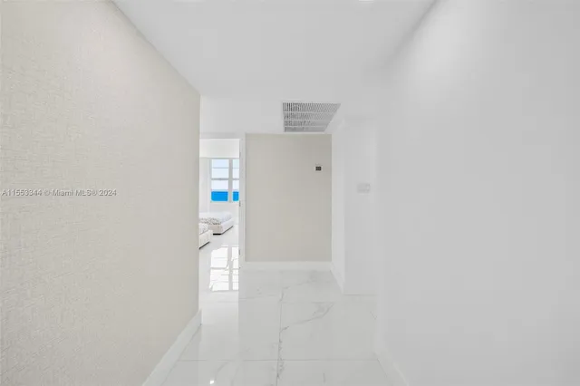 a living room with a bed furniture and a large window