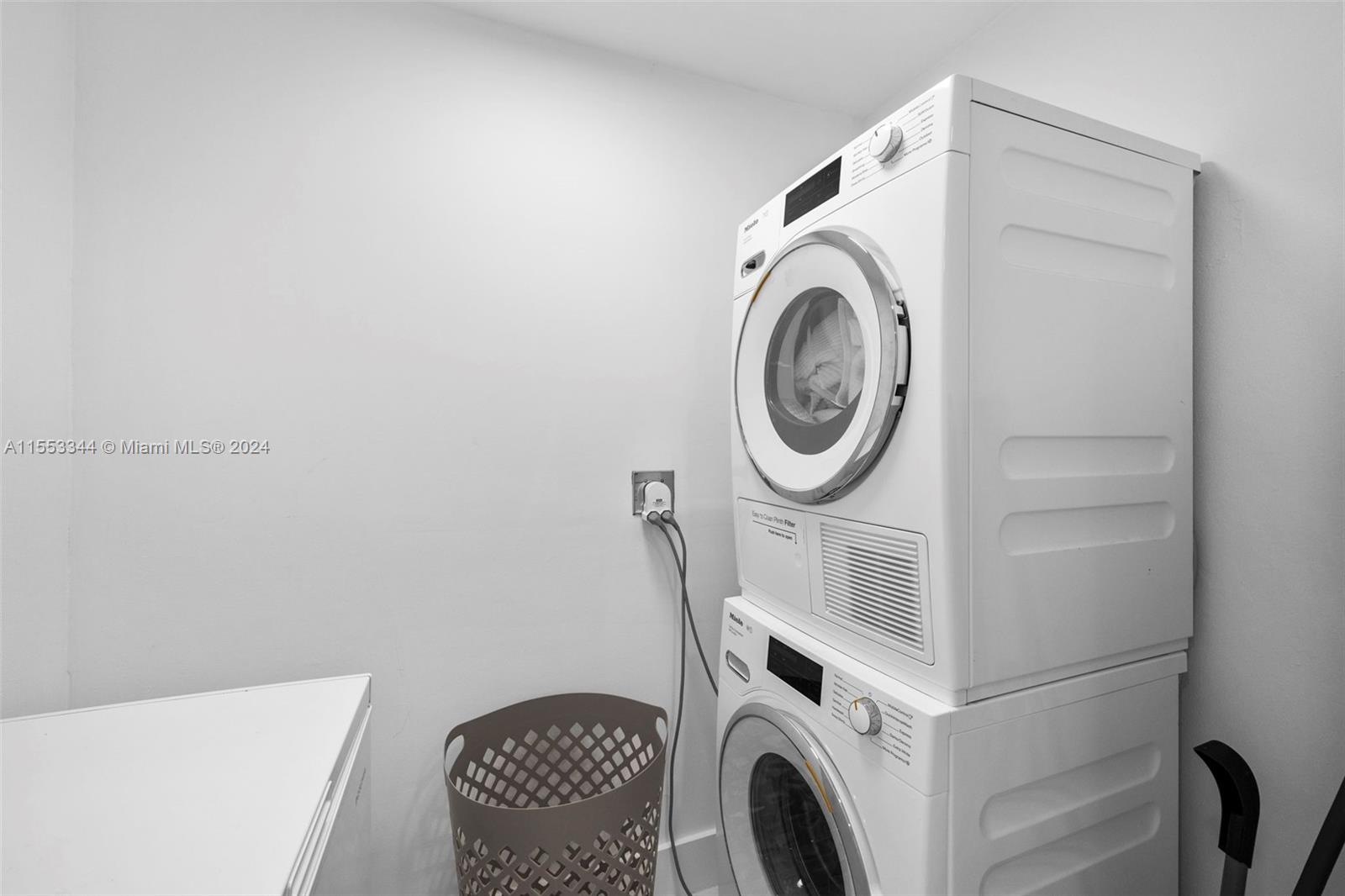 5151 Collins Avenue, Unit 1527 Miami Beach, FL 33140 - Photo 26 of 65 a utility room with dryer and washer