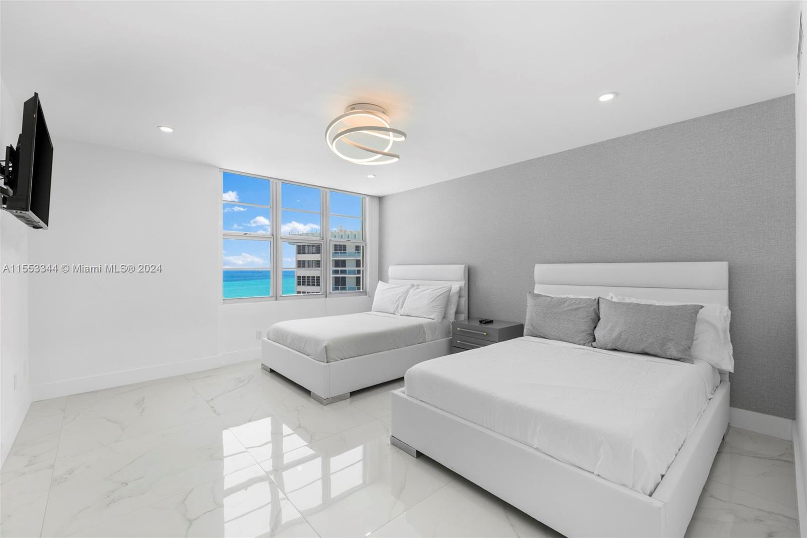 5151 Collins Avenue, Unit 1527 Miami Beach, FL 33140 - Photo 32 of 65 a bedroom with two beds and a window