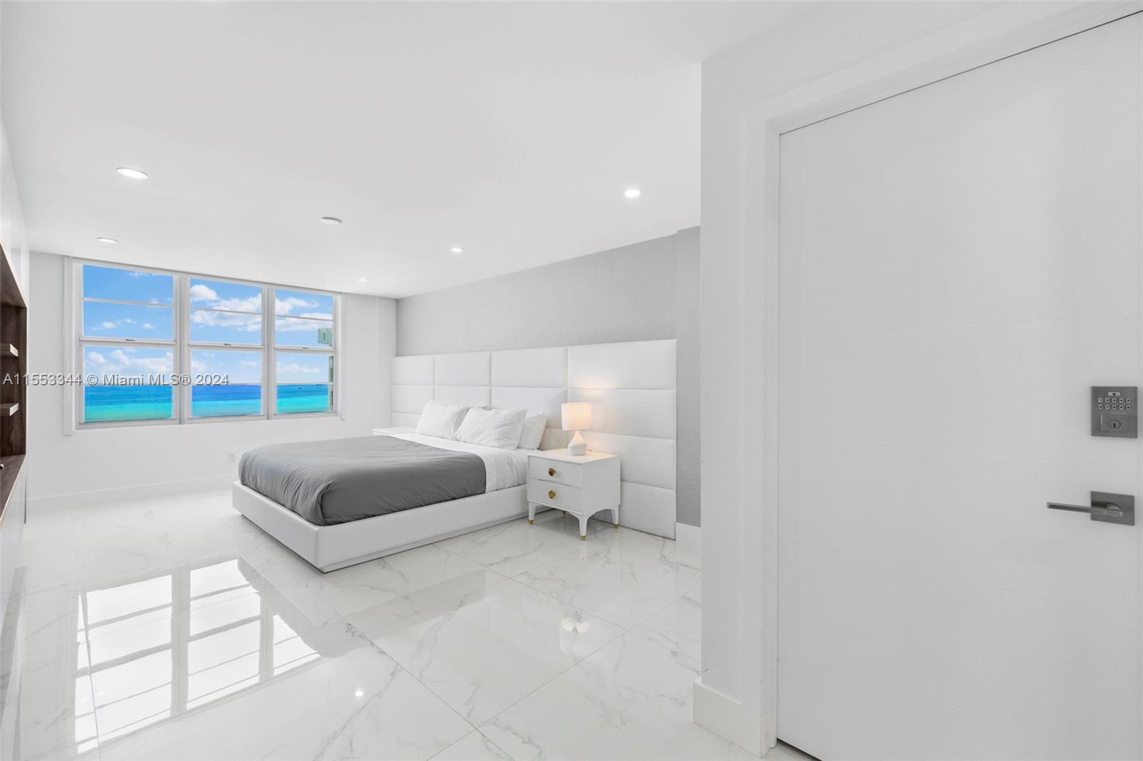 5151 Collins Avenue, Unit 1527 Miami Beach, FL 33140 - Photo 36 of 65 a bedroom with a bed and a large window