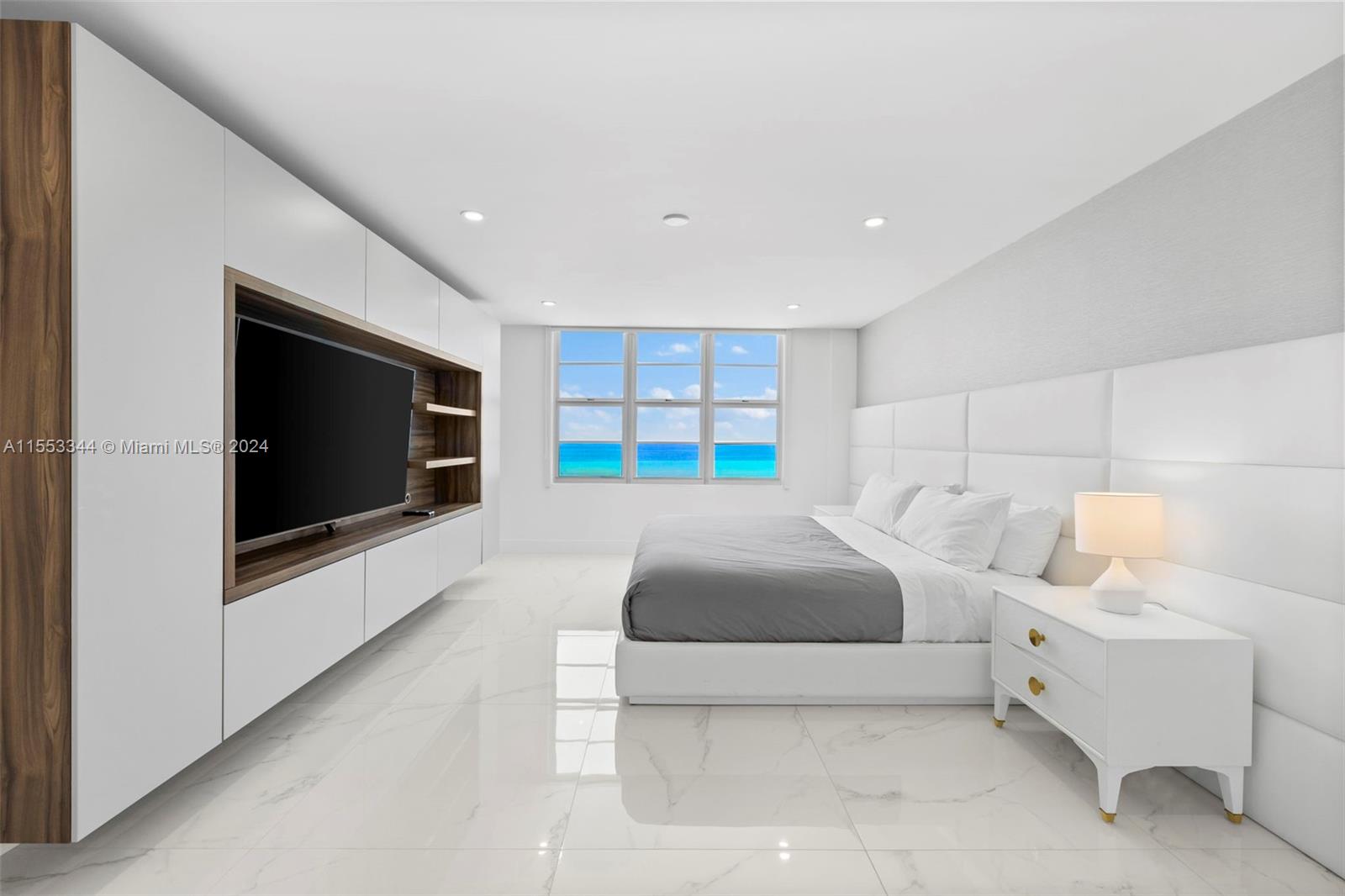 5151 Collins Avenue, Unit 1527 Miami Beach, FL 33140 - Photo 37 of 65 a living room with furniture and a flat screen tv