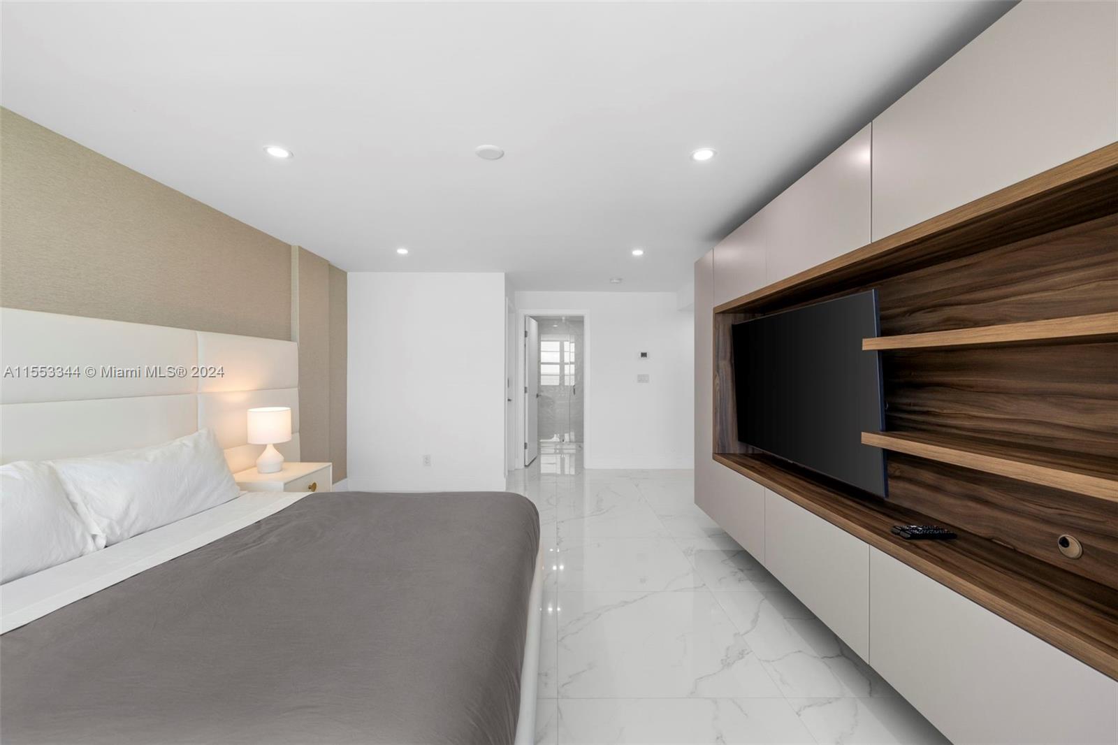 5151 Collins Avenue, Unit 1527 Miami Beach, FL 33140 - Photo 39 of 65 a living room with a flat screen tv