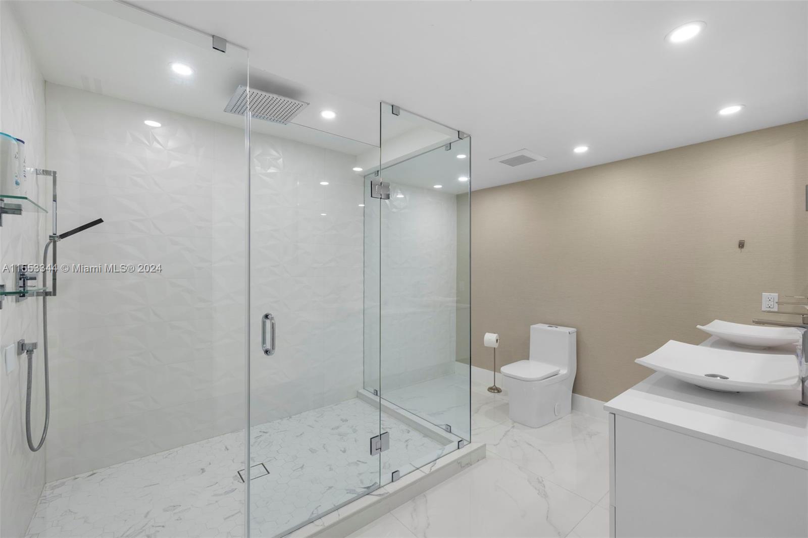 5151 Collins Avenue, Unit 1527 Miami Beach, FL 33140 - Photo 40 of 65 a bathroom with a shower a toilet and a sink