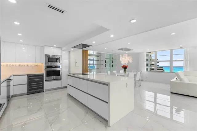 a kitchen with stainless steel appliances a stove microwave and refrigerator