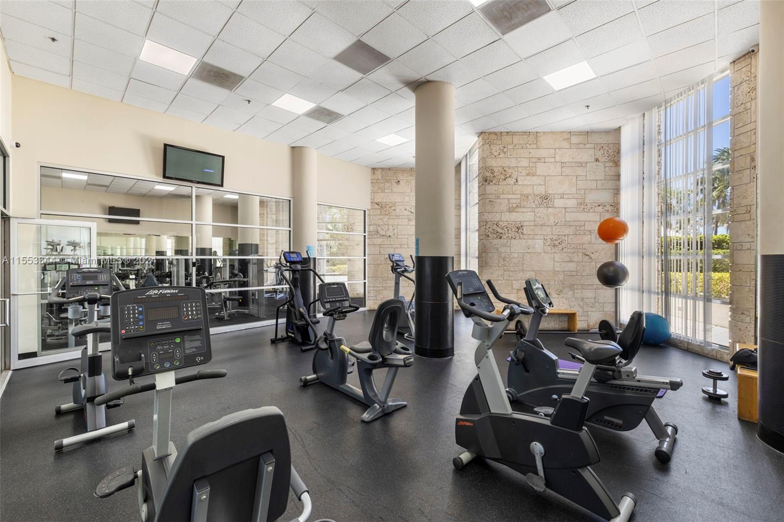 5151 Collins Avenue, Unit 1527 Miami Beach, FL 33140 - Photo 48 of 65 a view of a room with gym equipment