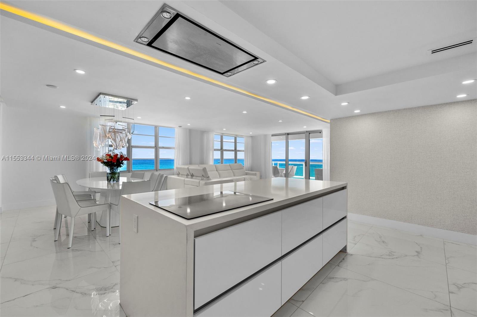 5151 Collins Avenue, Unit 1527 Miami Beach, FL 33140 - Photo 7 of 65 a kitchen with stainless steel appliances granite countertop a sink and a refrigerator