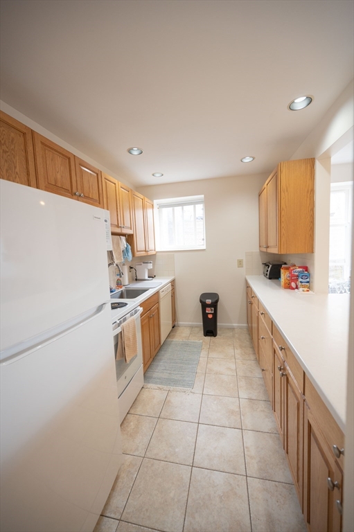 16 Addington Road, Unit 26 Brookline, MA 02445 - Photo 4 of 16 a kitchen with stainless steel appliances a refrigerator sink and cabinets