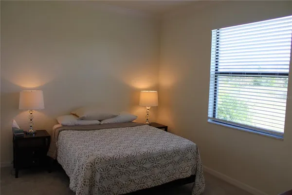 a bedroom with a bed and a lamp