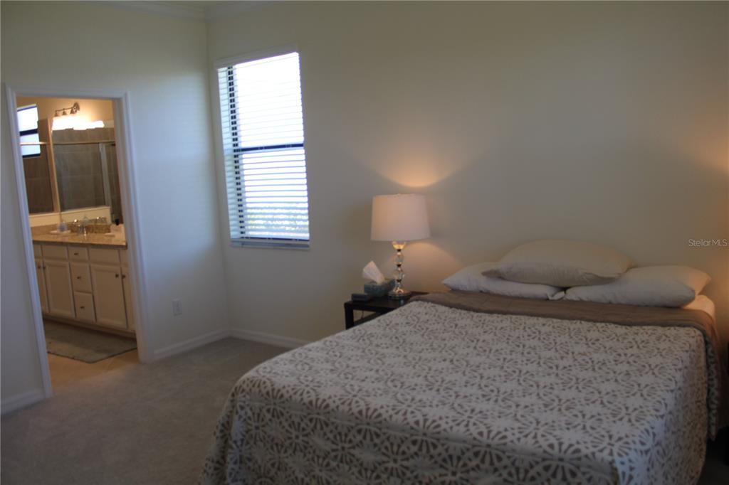 6647 Clairborne Lane Bradenton, FL 34211 - Photo 13 of 39 a bedroom with a bed and a window