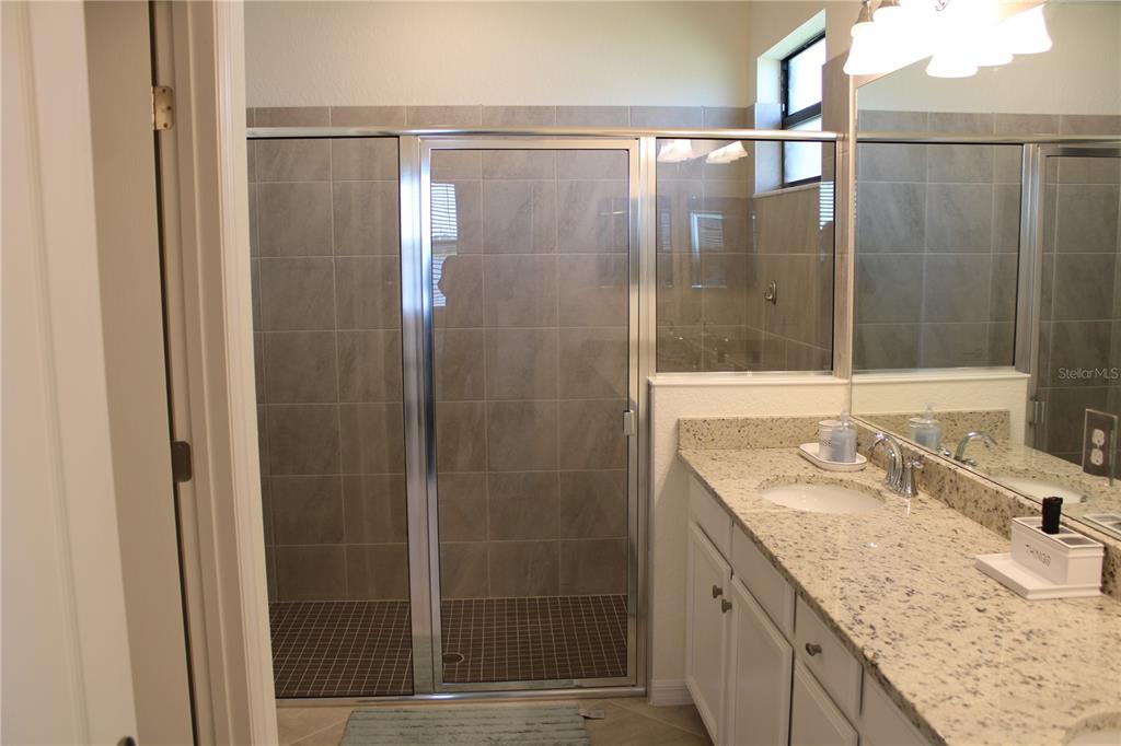 6647 Clairborne Lane Bradenton, FL 34211 - Photo 14 of 39 a bathroom with a granite countertop sink and mirror