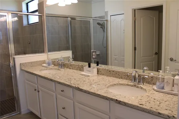 a bathroom with a granite countertop sink and a mirror