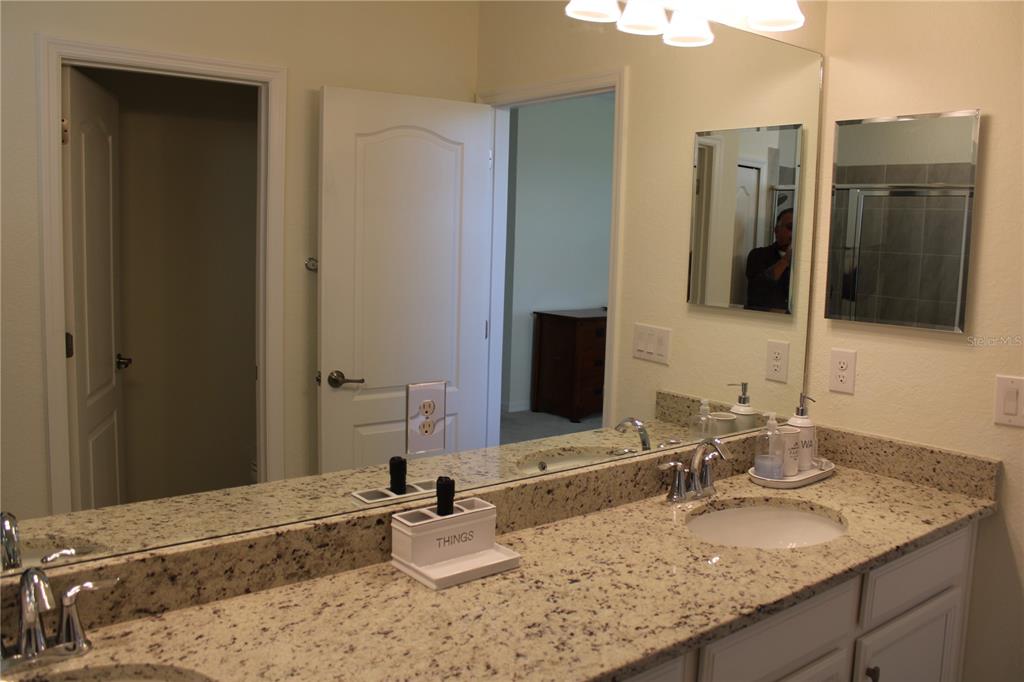 6647 Clairborne Lane Bradenton, FL 34211 - Photo 16 of 39 a bathroom with a granite countertop sink and a mirror