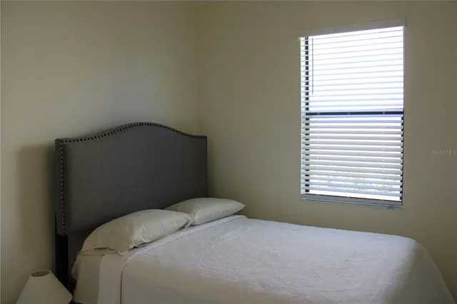a bedroom with a bed window and a window