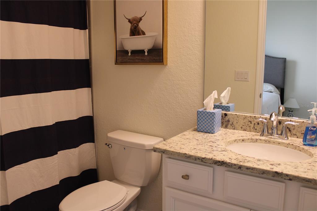 6647 Clairborne Lane Bradenton, FL 34211 - Photo 21 of 39 a bathroom with a granite countertop toilet sink and mirror