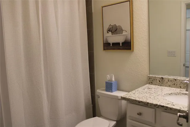 a bathroom with a sink toilet and vanity