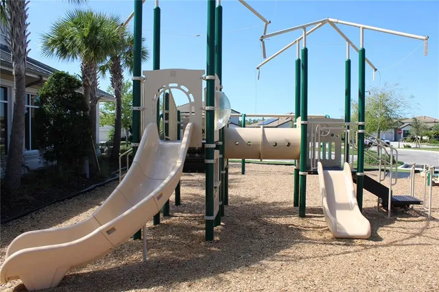 a view of a lake with table and chairs
